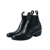 Front three-quarter view of the Chamula Botin Charro Leather Black showing the sleek ankle boot silhouette, smooth black leather upper, and elastic side panels for Clothier & Sons.