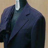 Lapel detail of the Drop6 Wool Suit Navy highlighting lapel shape, precise stitching, and understated formal finish for Clothier & Sons.