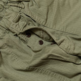Fabric detail of the Omnigod Men’s Herringbone Easy Baker Pants Olive revealing herringbone weave texture, durable cotton fabric, and earthy olive coloration for Clothier & Sons.