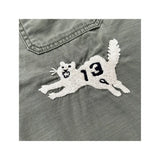 Close-up of the tiger embroidery on the Remi Relief Wide Military Shirt Charcoal showing thread texture, color detailing, and craftsmanship.