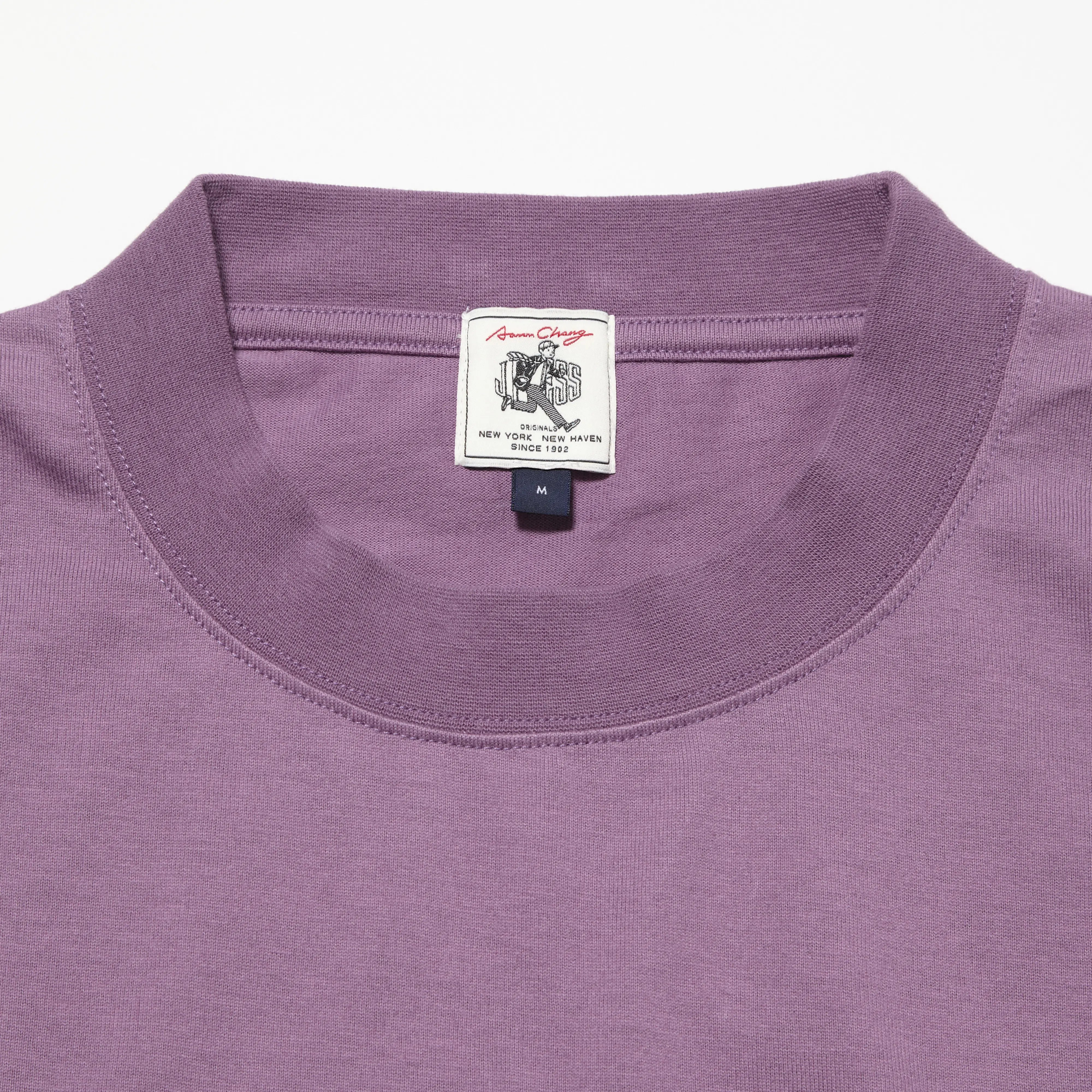 Collar detail of the J.Press Aaron Illust T-shirt Graphic Purple showing ribbed neckline construction and clean finishing for Clothier & Sons.
