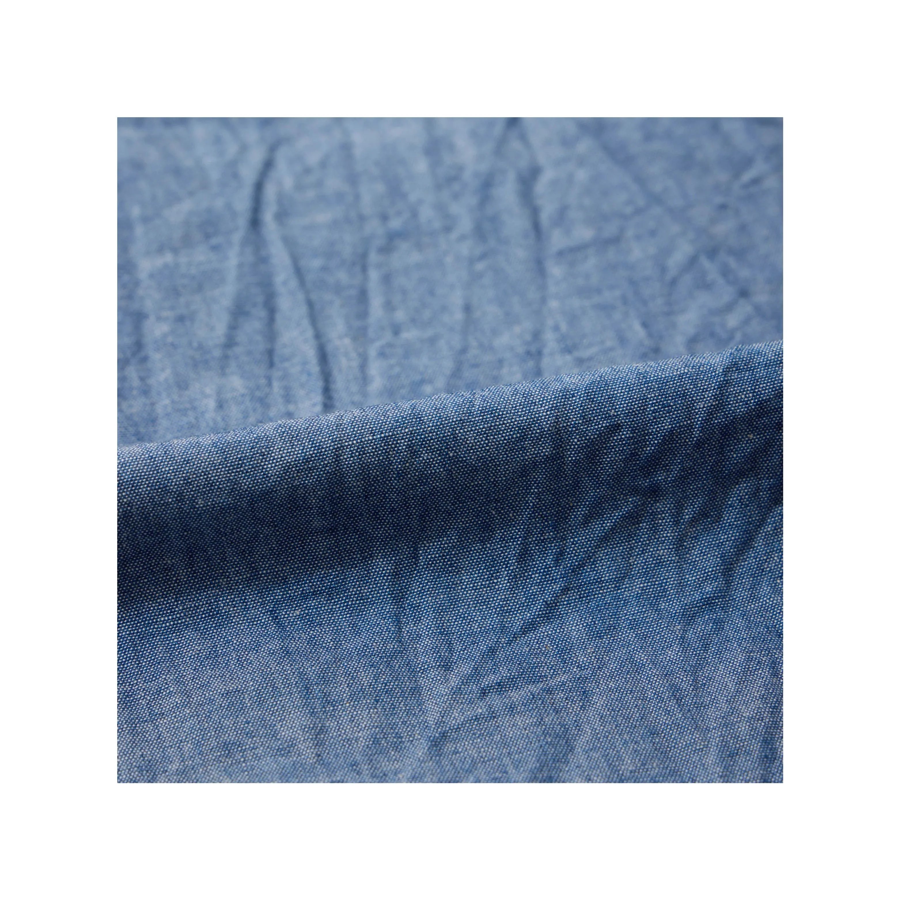 Close-up of indigo chambray fabric texture on Keaton Chase USA pullover shirt