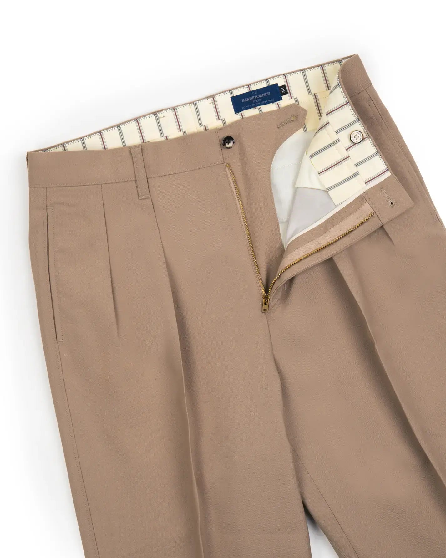 Waist detail of the Barnstormer Double Pleat Chino 1953 Wool Beige showing waistband construction, belt loops, and fastening detail for Clothier & Sons.
