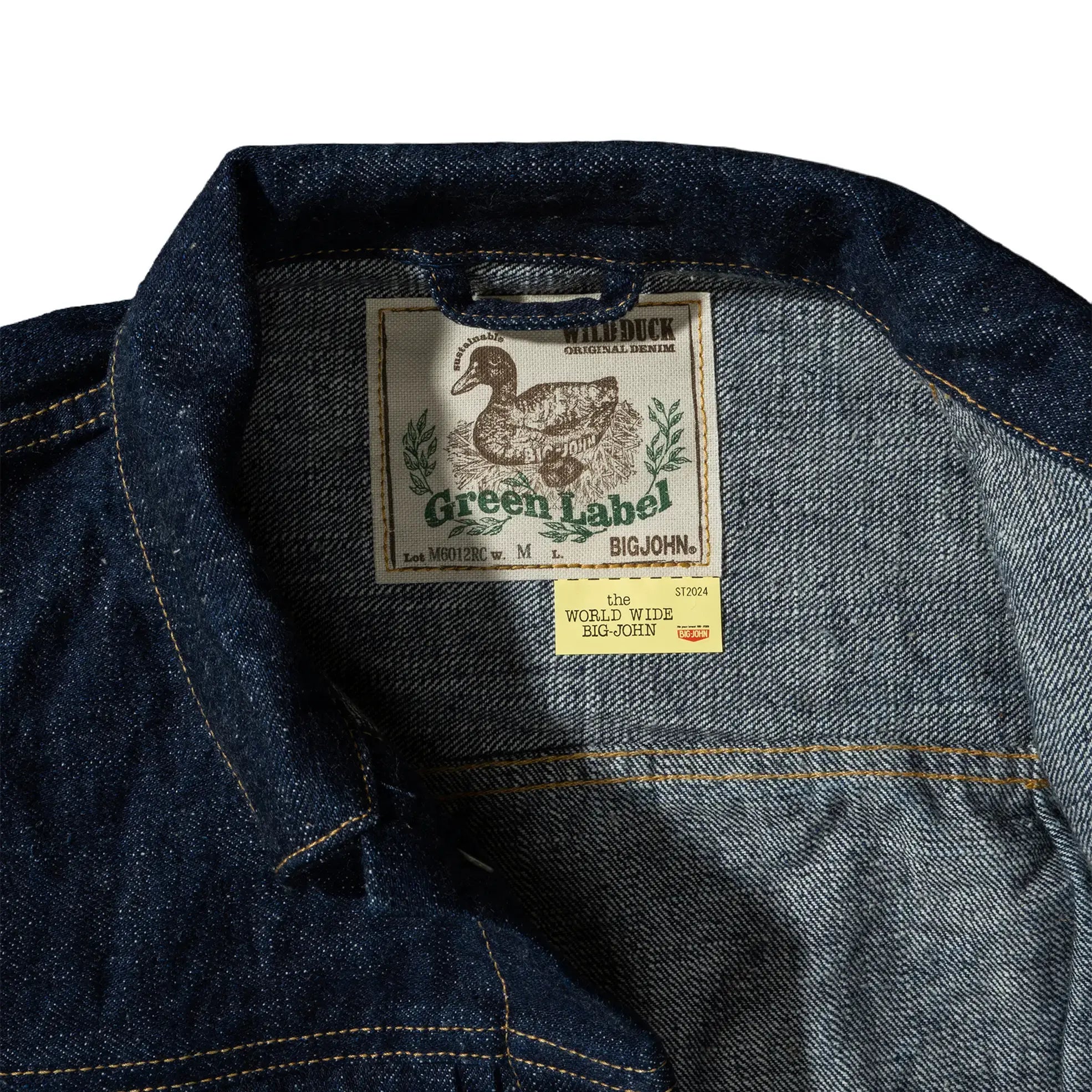 Neck label detail of the Big John M6012RC 16oz Green Label Wild Duck Jacket showing the Green Label branding, label stitching, and garment identification for Clothier & Sons.