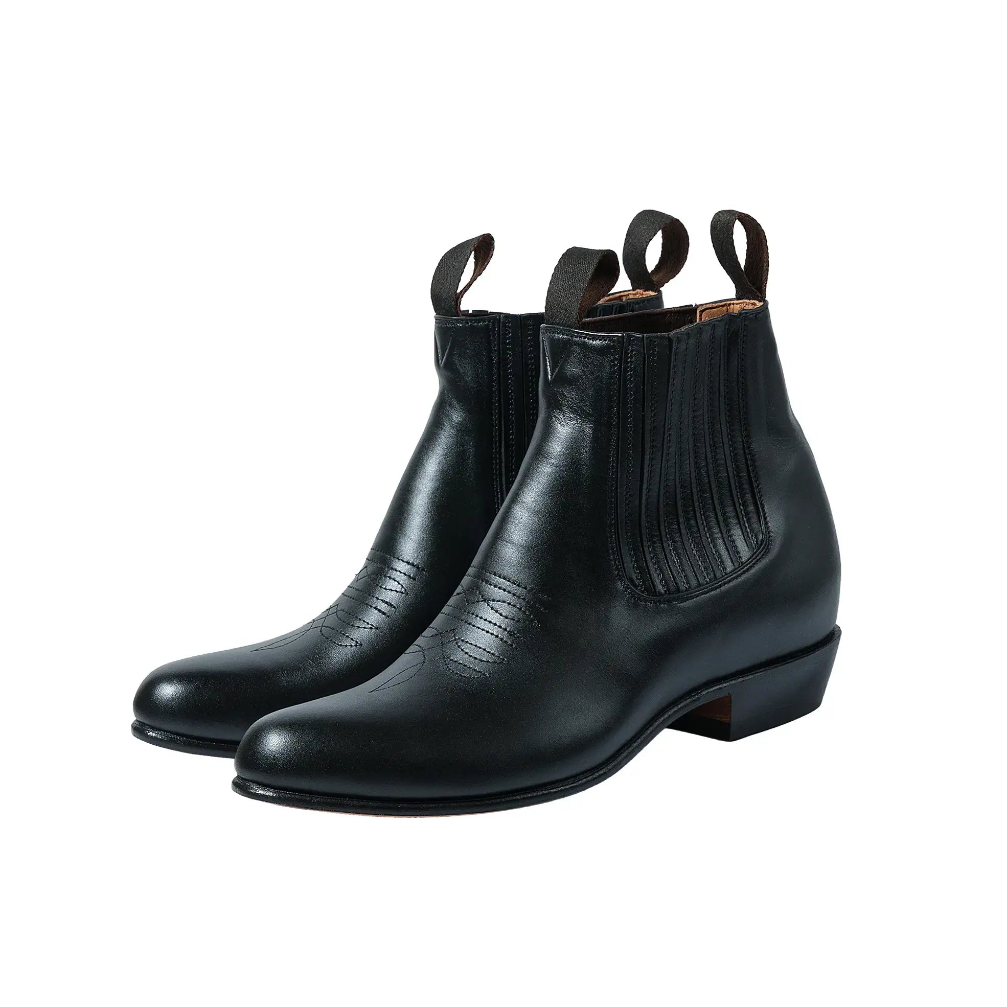 Front three-quarter view of the Chamula Botin Charro Leather Black showing the sleek ankle boot silhouette, smooth black leather upper, and elastic side panels for Clothier & Sons.