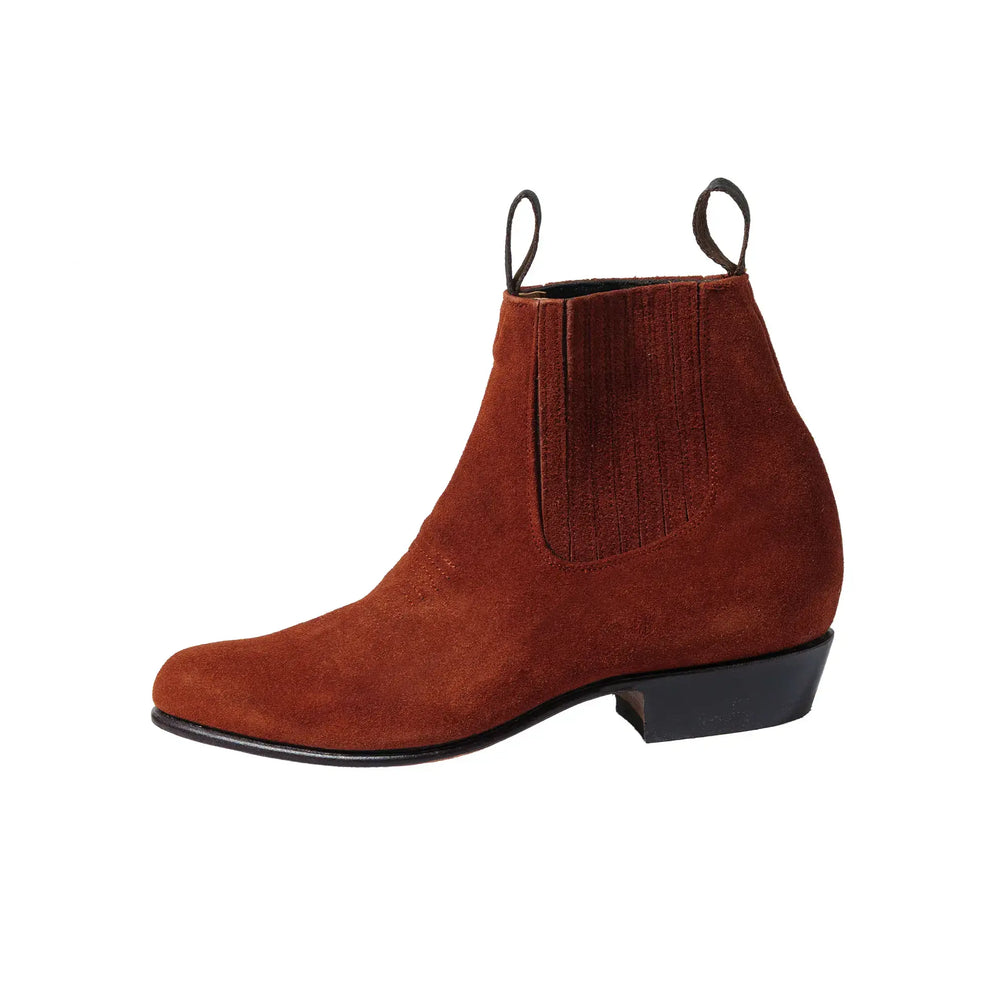 Side profile of the Chamula Botin Charro Suede Ante Tabaco showing elastic gusset panel, stacked heel, and refined ankle height proportion for Clothier & Sons.
