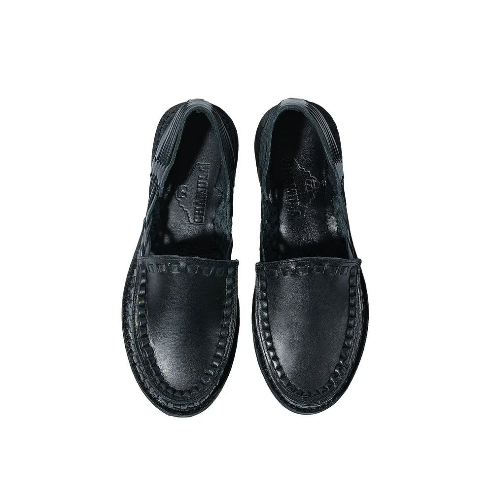 Side profile of the Chamula Durango Black showing ankle height proportion, stacked heel, and refined handcrafted silhouette for Clothier & Sons.