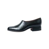 Side profile of the Chamula Saarinen Black Leather showing ankle height proportion, stacked heel, and refined silhouette for Clothier & Sons.
