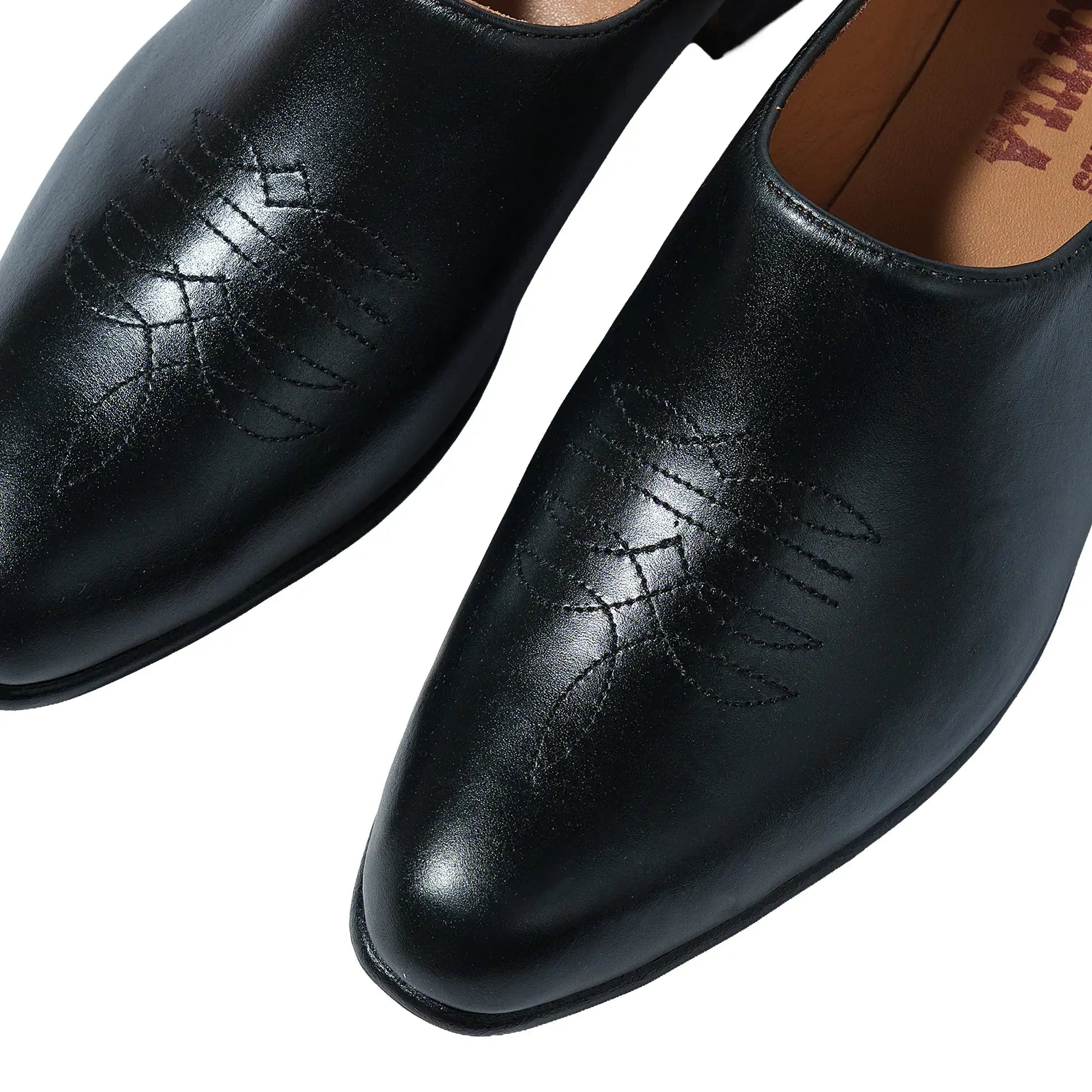 Side profile of the Chamula Saarinen Black Leather showing ankle height proportion, stacked heel, and refined silhouette for Clothier & Sons.