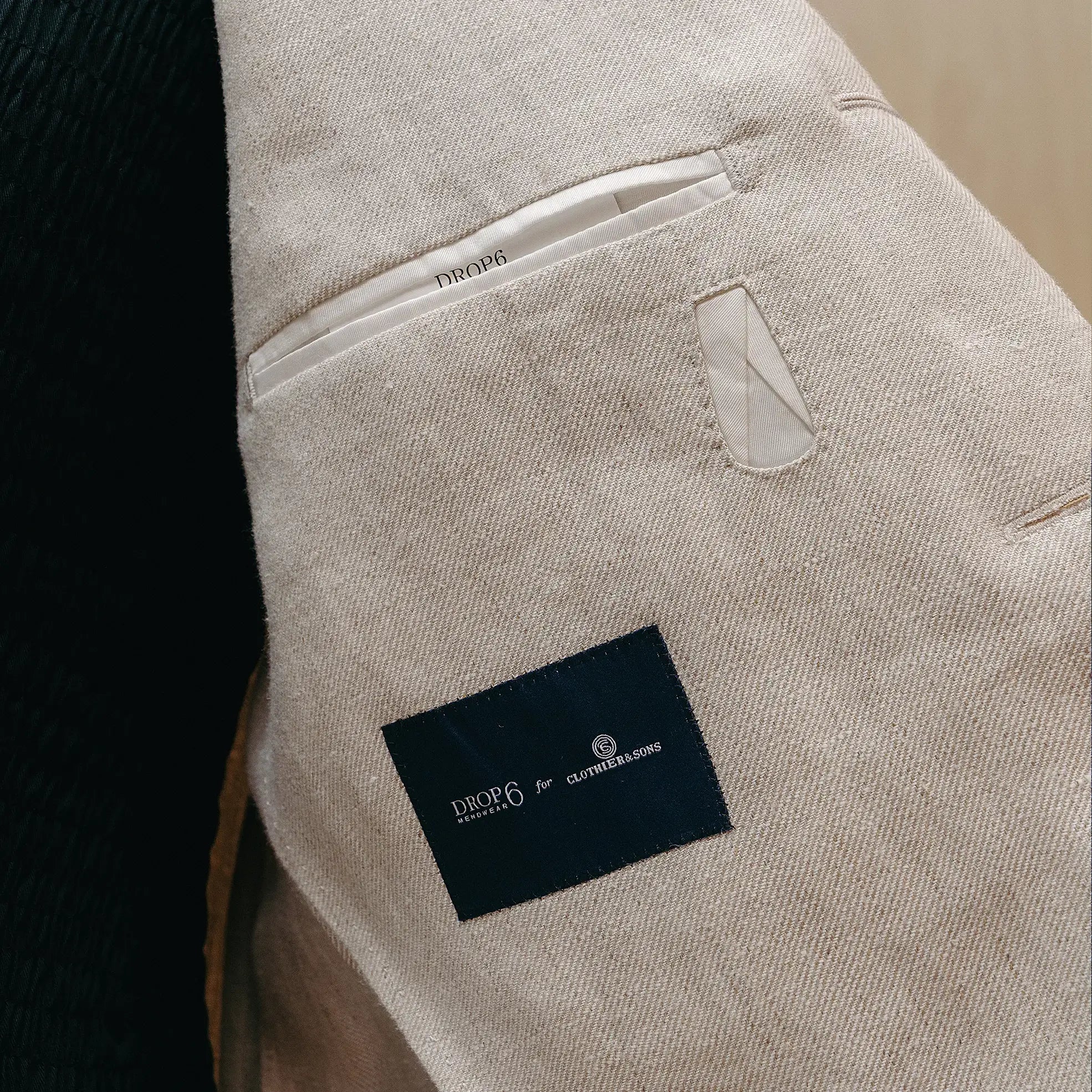 Fabric detail of the Drop6 Linen Suit Oatmeal revealing linen weave texture, natural oatmeal color, and airy material character for Clothier & Sons.