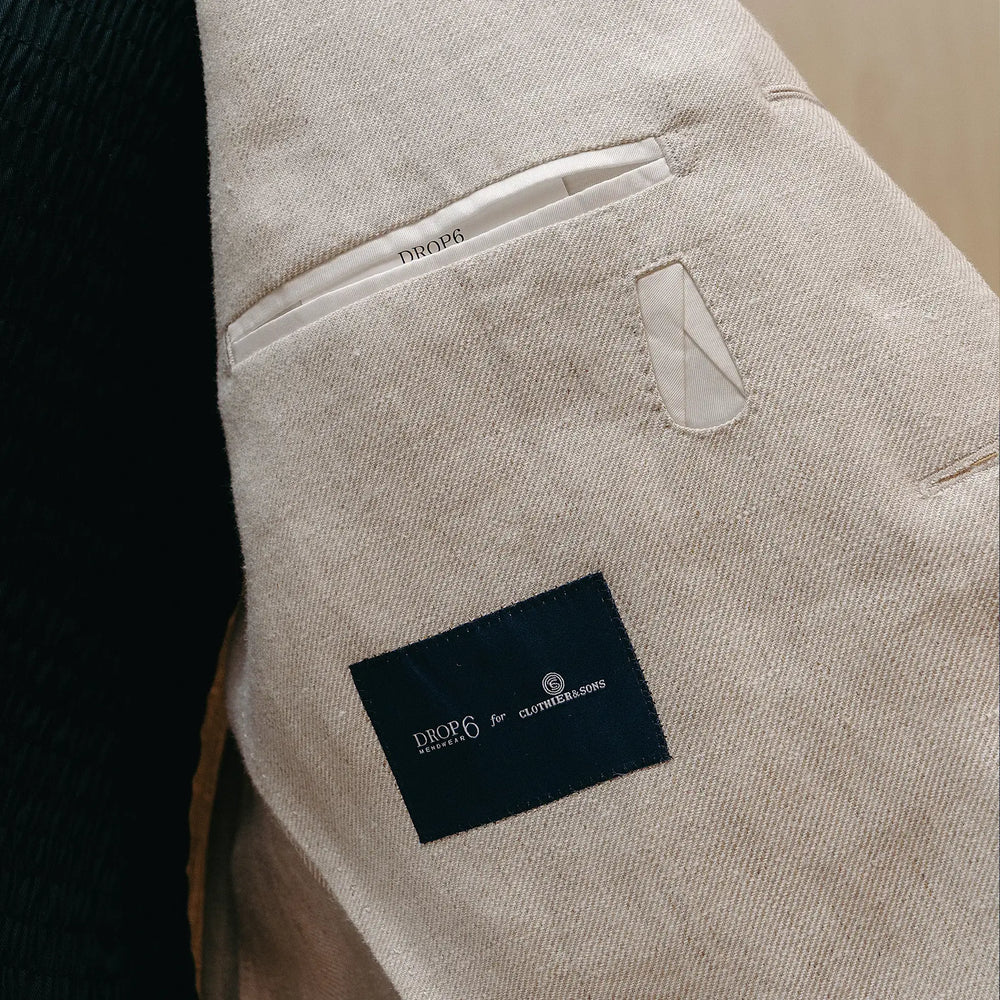 Fabric detail of the Drop6 Linen Suit Oatmeal revealing linen weave texture, natural oatmeal color, and airy material character for Clothier & Sons.