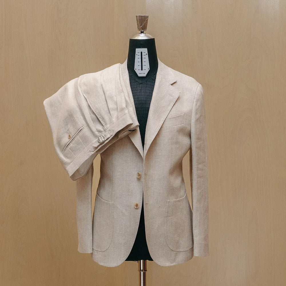 Front view of the Drop6 Linen Suit Oatmeal showing the single breasted silhouette, soft oatmeal tone, and relaxed tailored structure for Clothier & Sons.