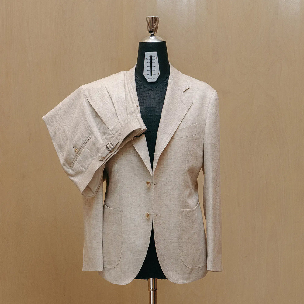 Front view of the Drop6 Linen Tencel Herringbone Suit Ivory showing the single breasted silhouette, soft ivory tone, and refined tailoring for Clothier & Sons.