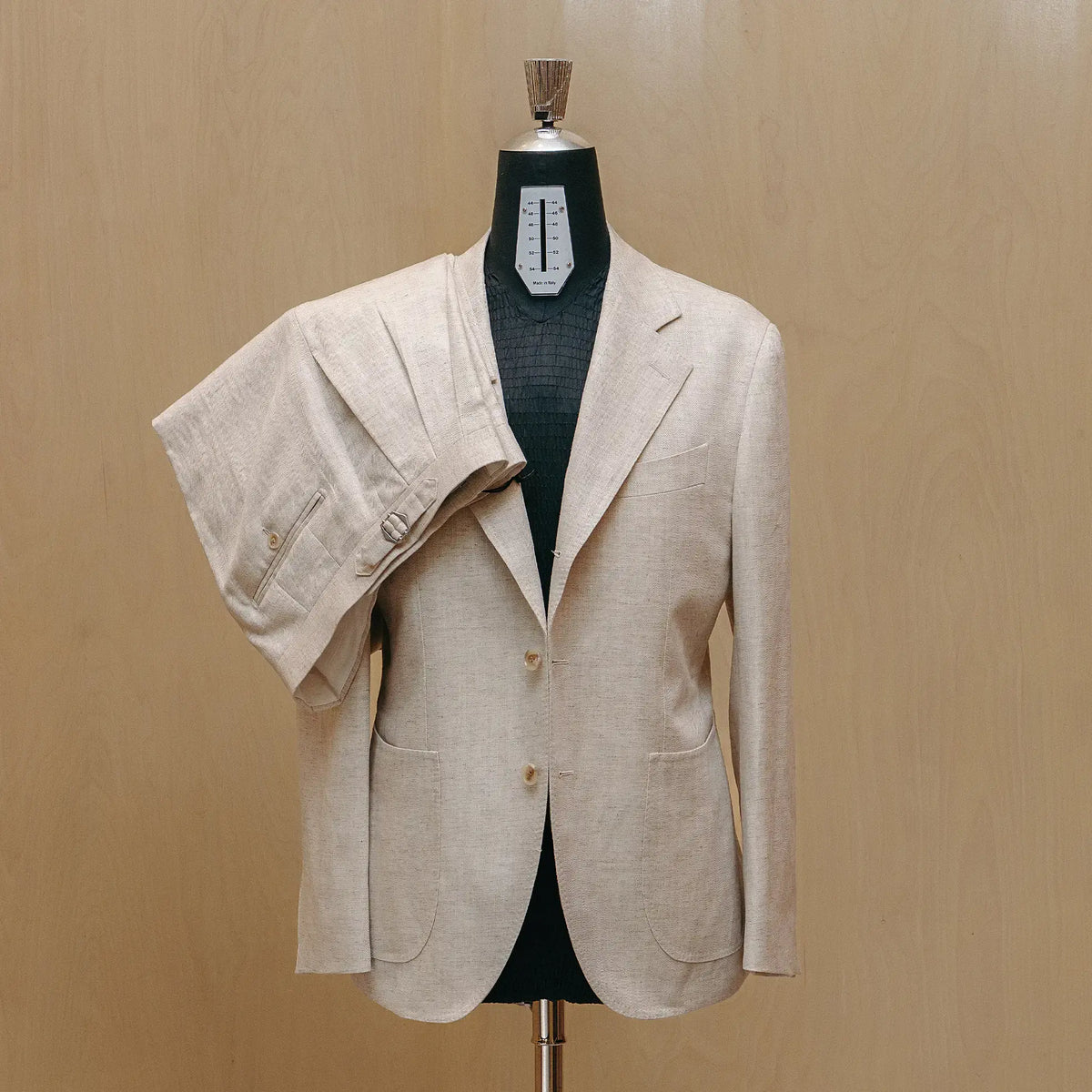 Front view of the Drop6 Linen Tencel Herringbone Suit Ivory showing the single breasted silhouette, soft ivory tone, and refined tailoring for Clothier & Sons.