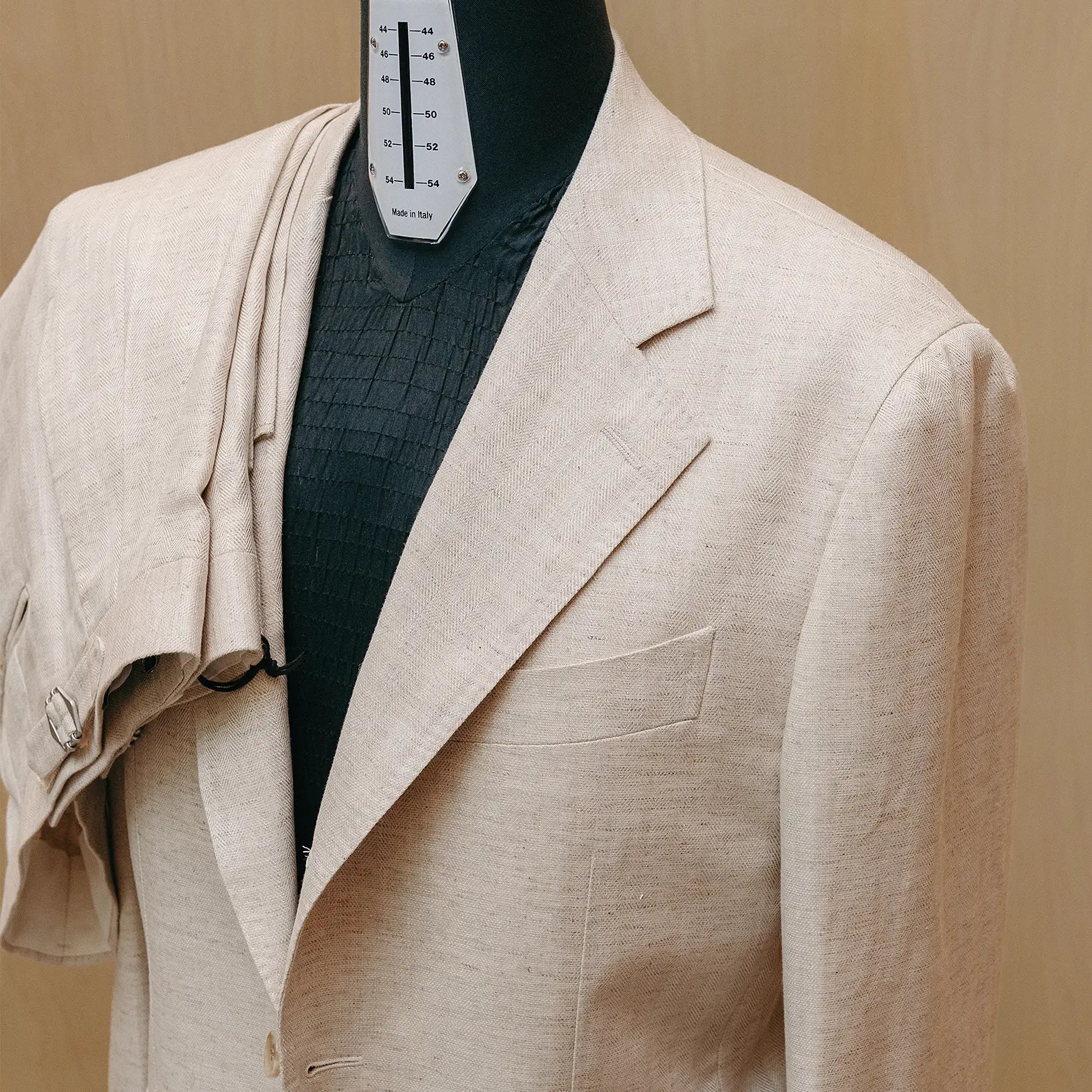Lapel detail of the Drop6 Linen Tencel Herringbone Suit Ivory highlighting lapel shape, stitching, and subtle herringbone pattern for Clothier & Sons.