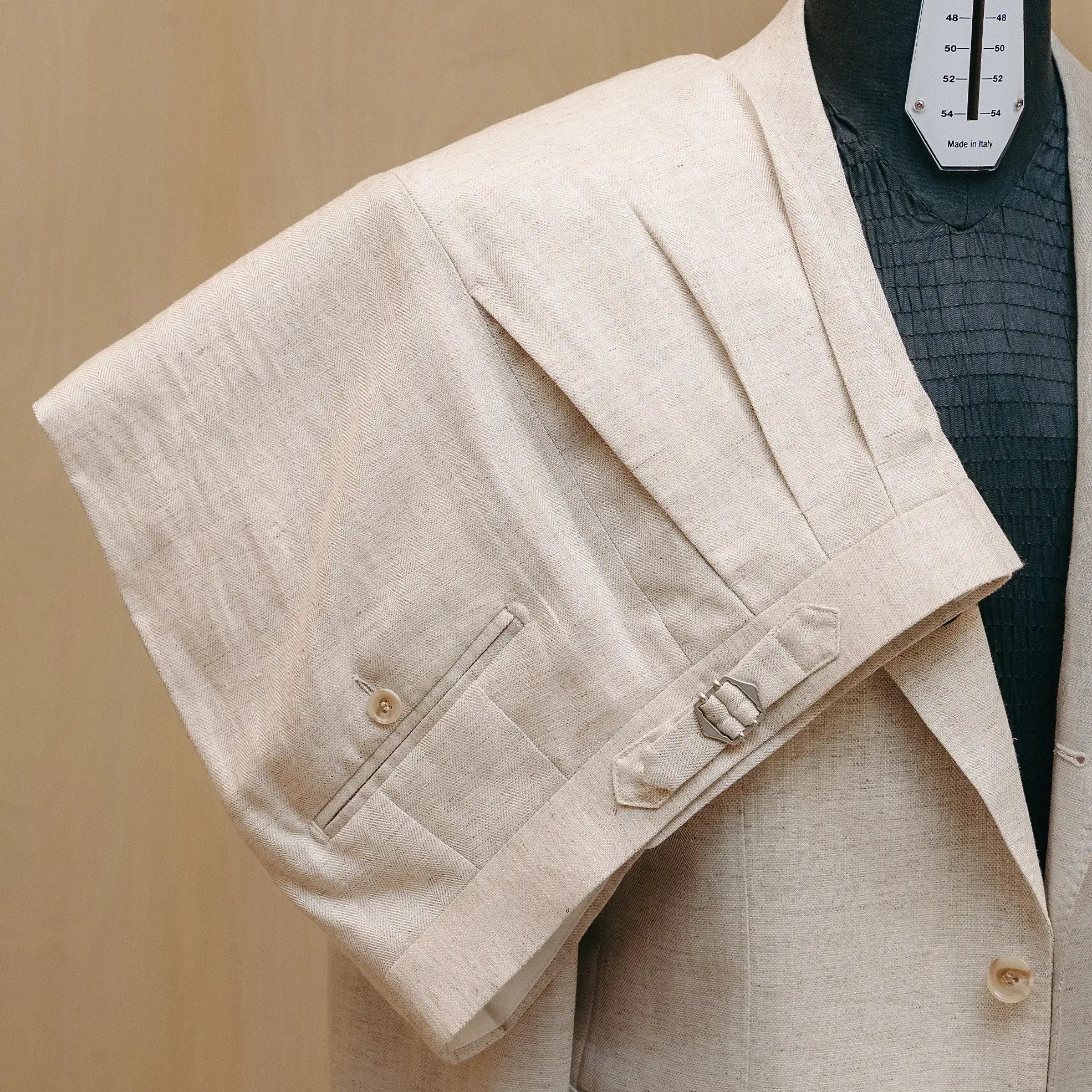 Shoulder detail of the Drop6 Linen Tencel Herringbone Suit Ivory showing natural shoulder structure, fabric drape, and herringbone texture for Clothier & Sons.