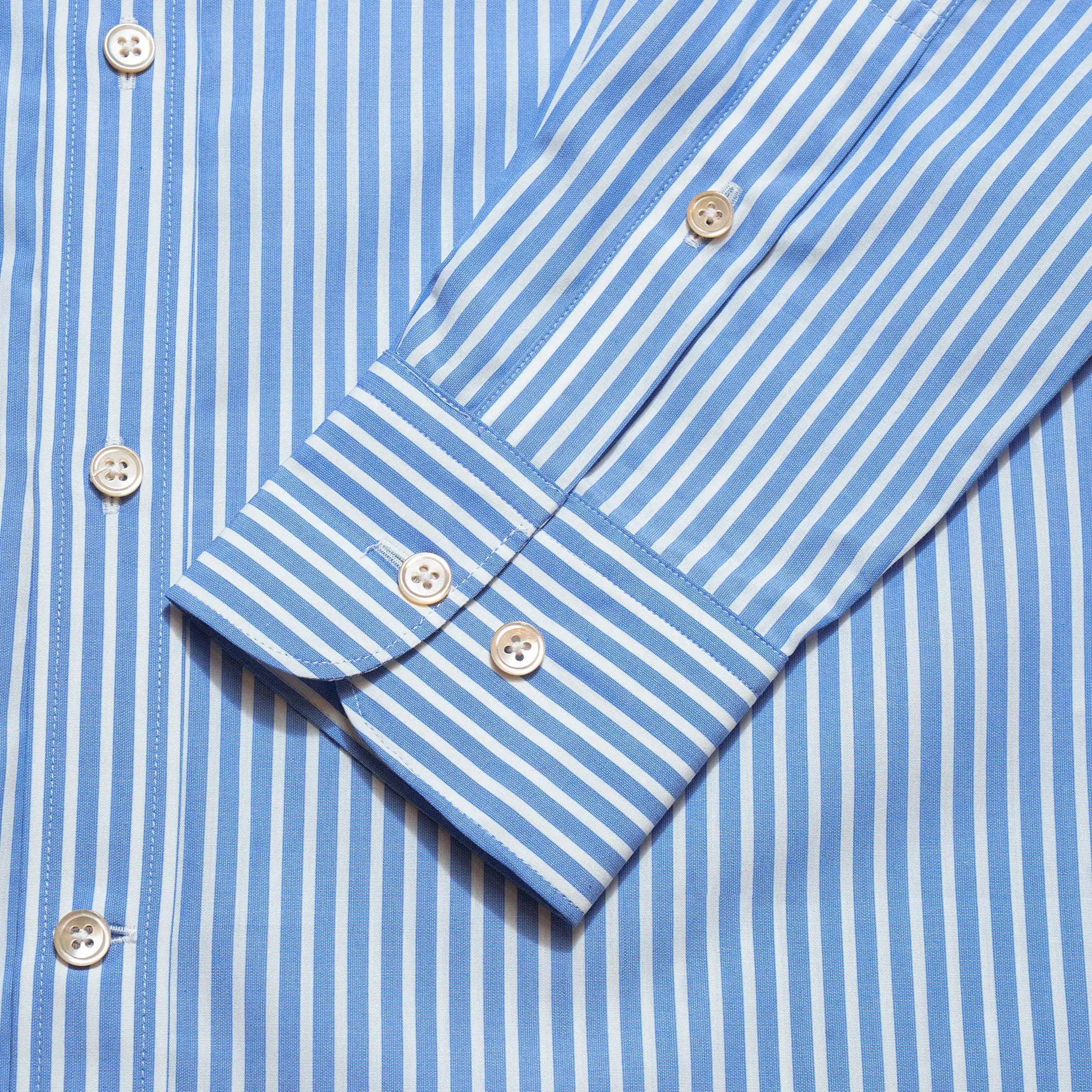 Cuff detail of the Drop6 New Bengal Stripe Button Down Shirt Blue showing sleeve placket construction and button fastening for Clothier & Sons.
