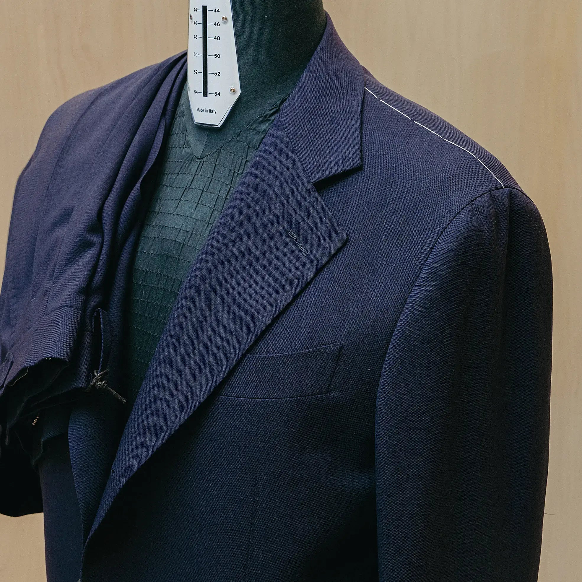 Lapel detail of the Drop6 Wool Suit Navy highlighting lapel shape, precise stitching, and understated formal finish for Clothier & Sons.