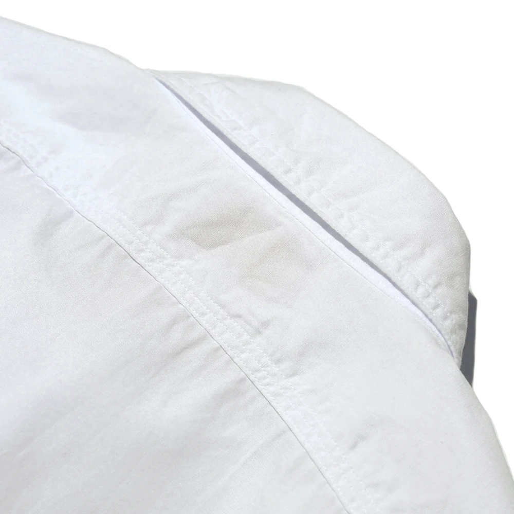 Side profile of the Jelado Smoker Shirt White showing shirt length, sleeve shape, and relaxed vintage fit for Clothier & Sons.