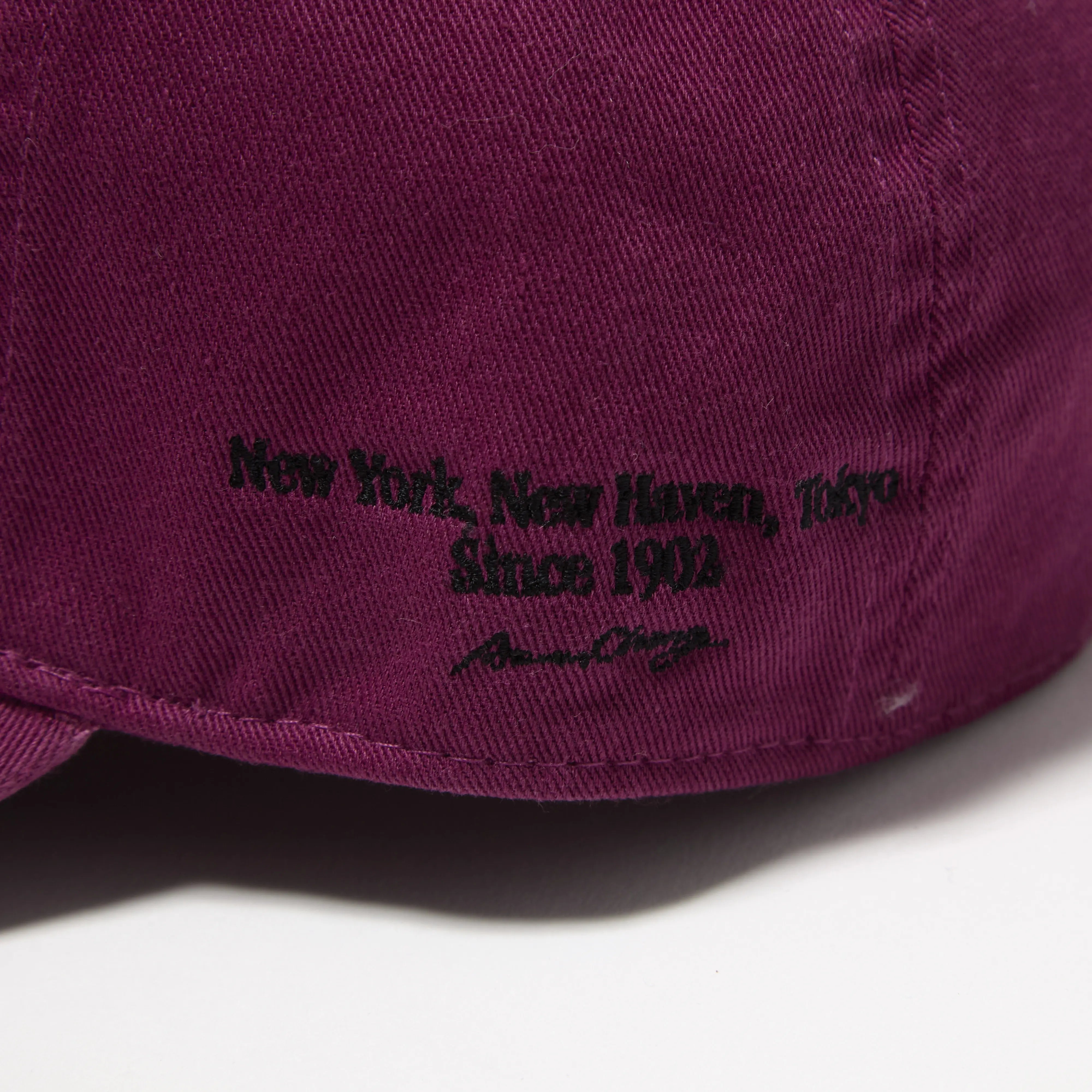 Fabric detail of the J.Press Aaron Chang Cotton Twill Baseball Cap Purple revealing cotton twill texture and durable weave for Clothier & Sons.