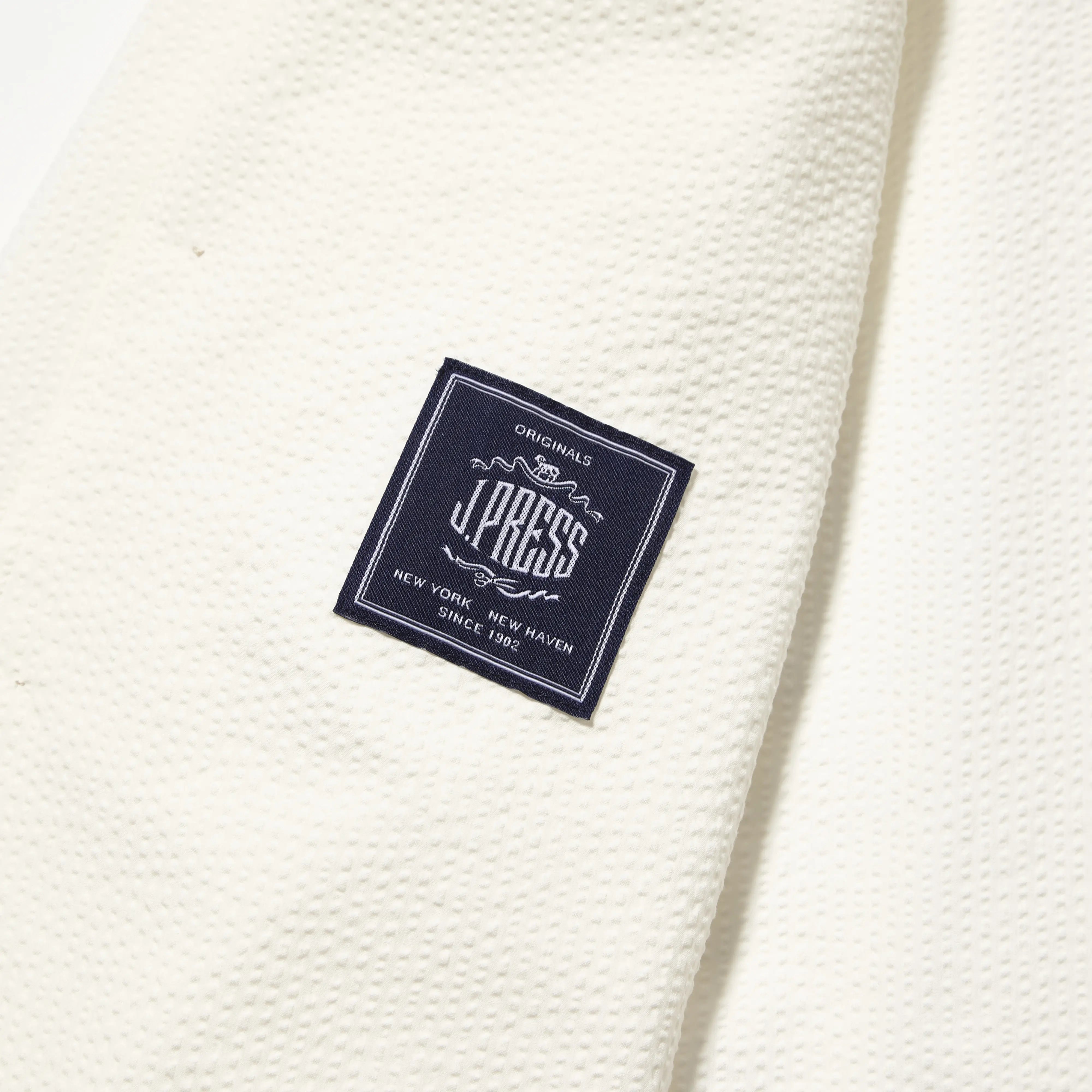Inside label of the J.Press Silk Seersucker 3B Sack Jacket White showing brand identification and size information for Clothier & Sons.
