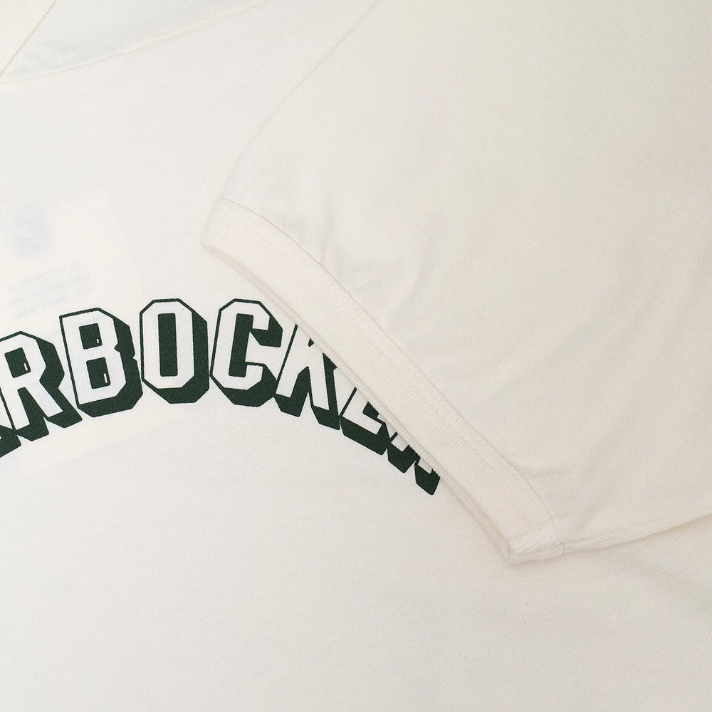 Fabric detail of the Knickerbocker Track Tee Milk revealing cotton jersey texture, soft hand feel, and smooth milk color tone for Clothier & Sons.