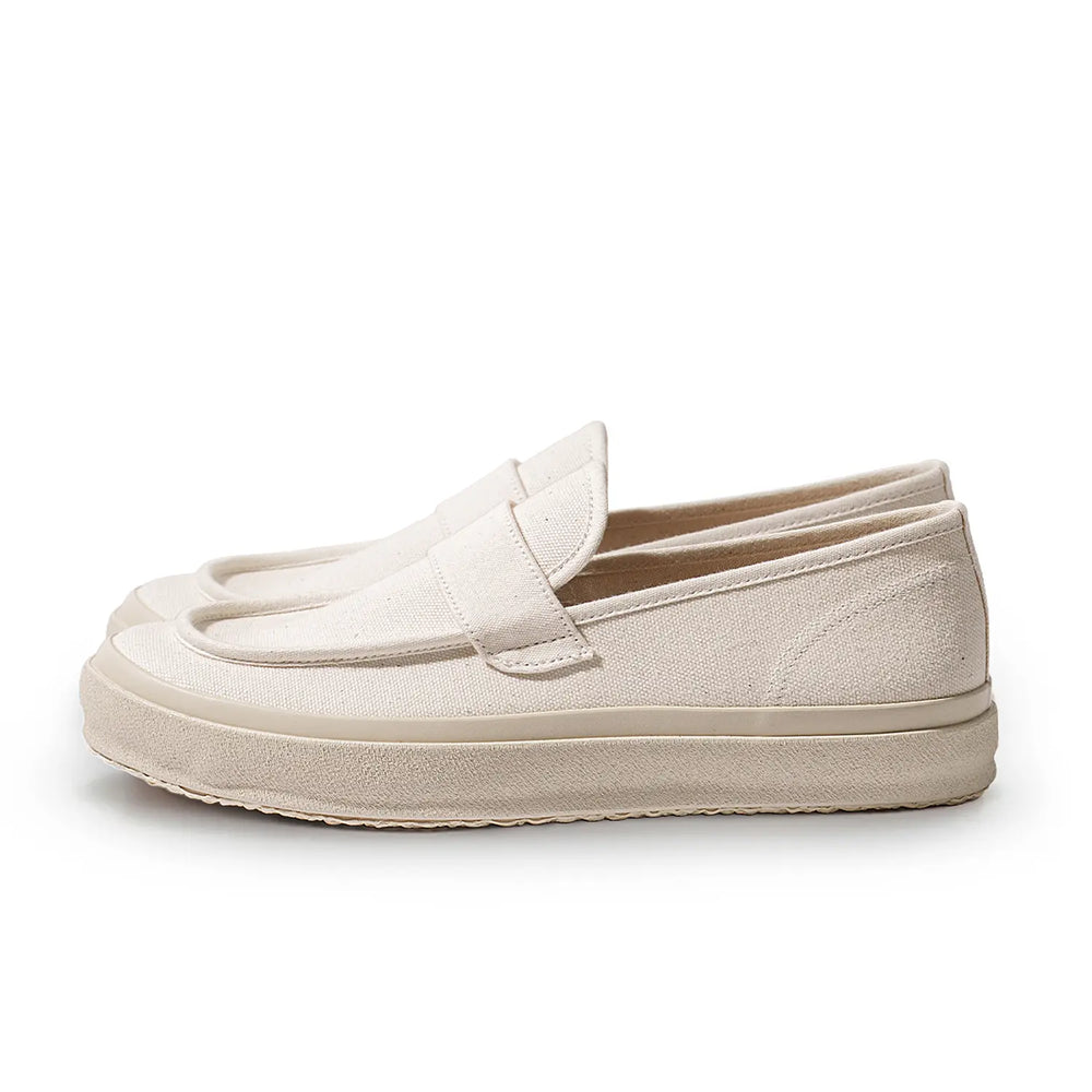 Side profile of the Moonstar Loafy Natural showing the low-cut slip-on silhouette, natural canvas upper, and thick rubber sole for Clothier & Sons.
