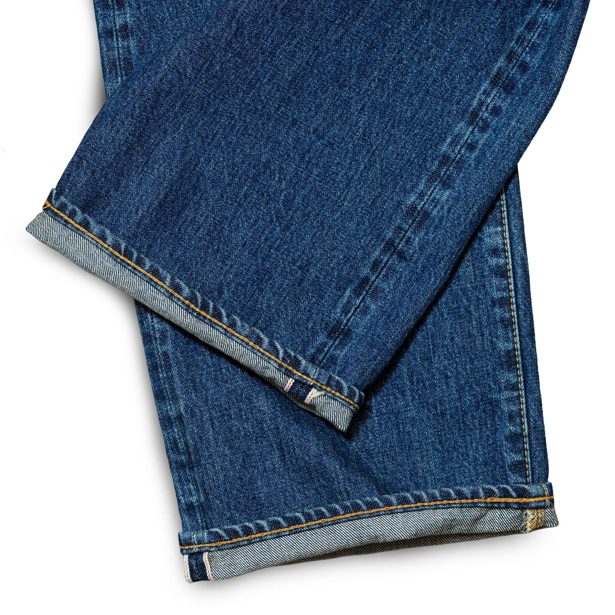 Fabric detail of the Omnigod Clothier & Sons Selvedge Used Wash Jeans revealing selvedge denim texture, worn-in wash effects, and depth of indigo tone for Clothier & Sons.