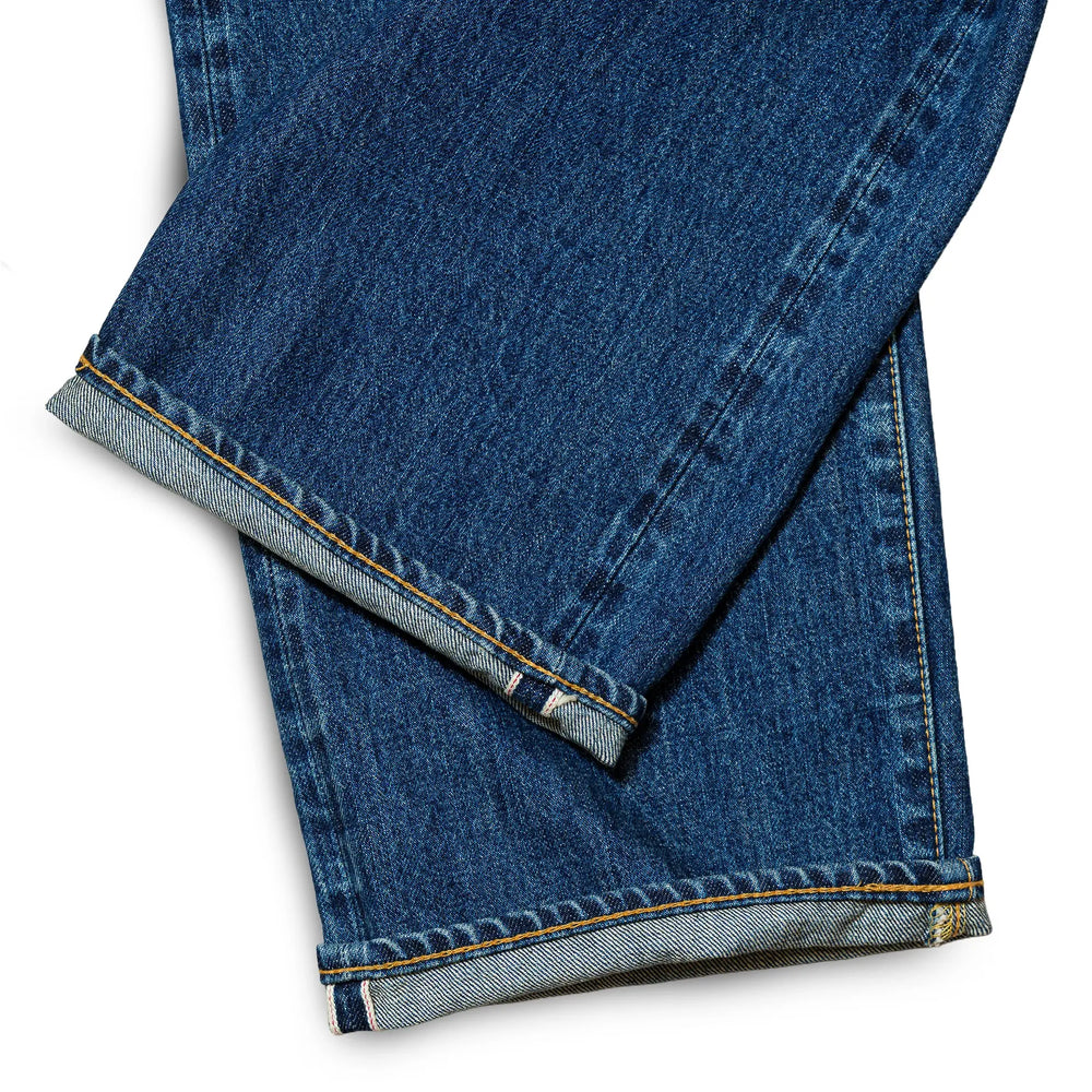 Fabric detail of the Omnigod Clothier & Sons Selvedge Used Wash Jeans revealing selvedge denim texture, worn-in wash effects, and depth of indigo tone for Clothier & Sons.
