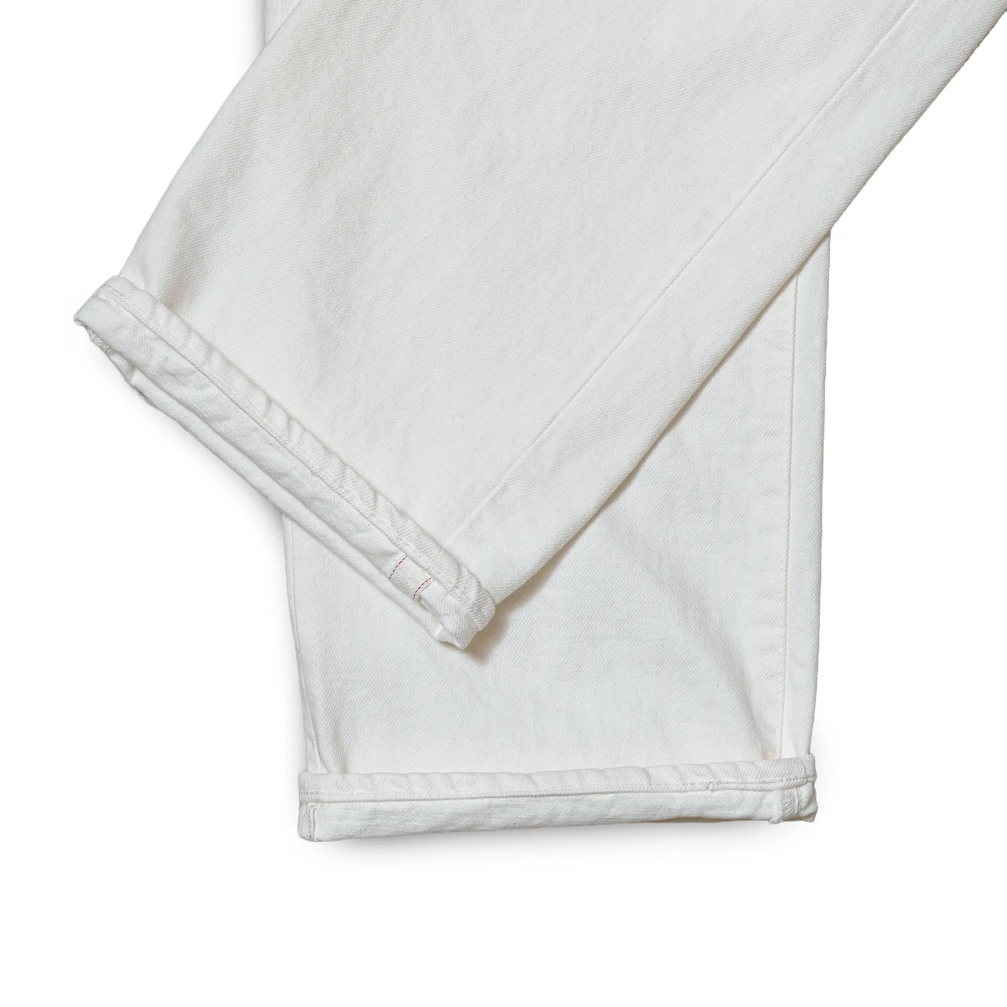 Fabric detail of the Omnigod Clothier & Sons Selvedge White Jeans revealing selvedge denim texture, tight weave structure, and bright white coloration for Clothier & Sons.