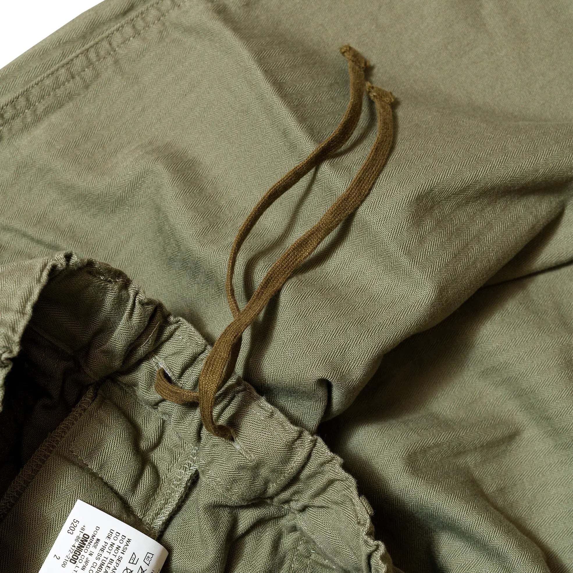 Waist detail of the Omnigod Men’s Herringbone Easy Baker Pants Olive showing elastic waistband construction, belt loops, and stitching finish for Clothier & Sons.