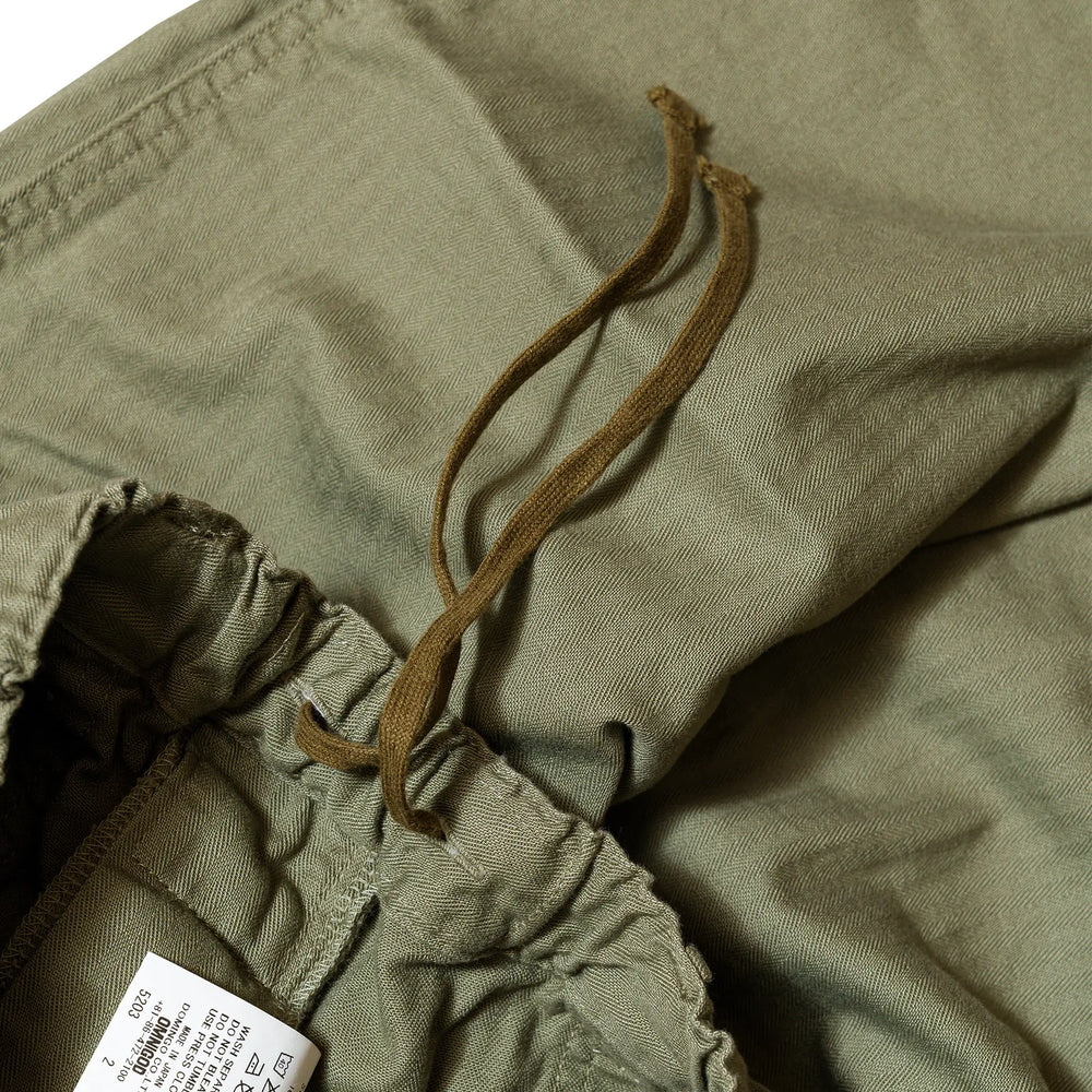 Waist detail of the Omnigod Men’s Herringbone Easy Baker Pants Olive showing elastic waistband construction, belt loops, and stitching finish for Clothier & Sons.