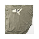 Close-up of the tiger embroidery on the Remi Relief Wide Military Shirt Khaki showing thread texture, color detailing, and hand-finished appearance.