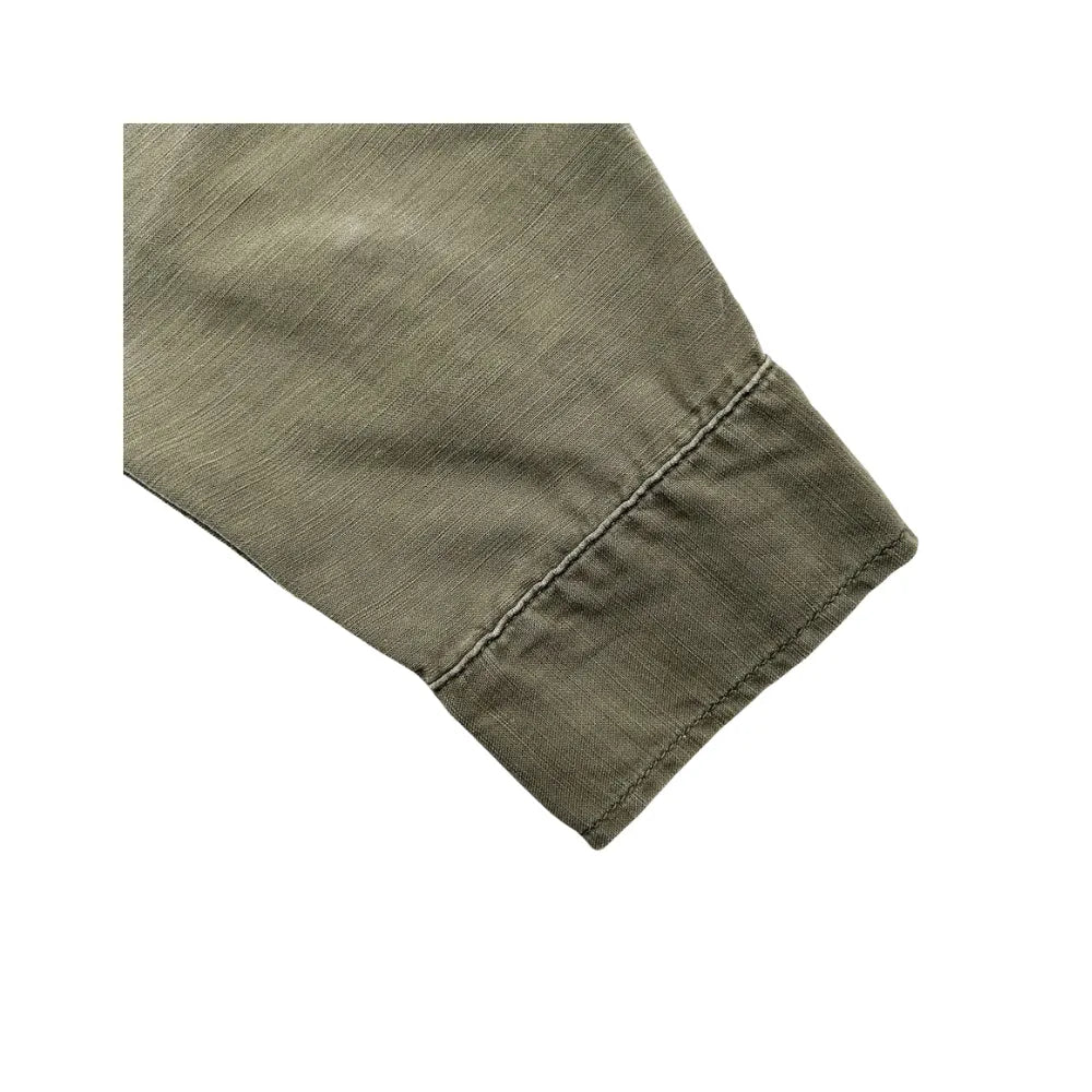 Close-up of the khaki cotton fabric on the Remi Relief Military Shirt showing the weave, texture, and garment-dyed character.