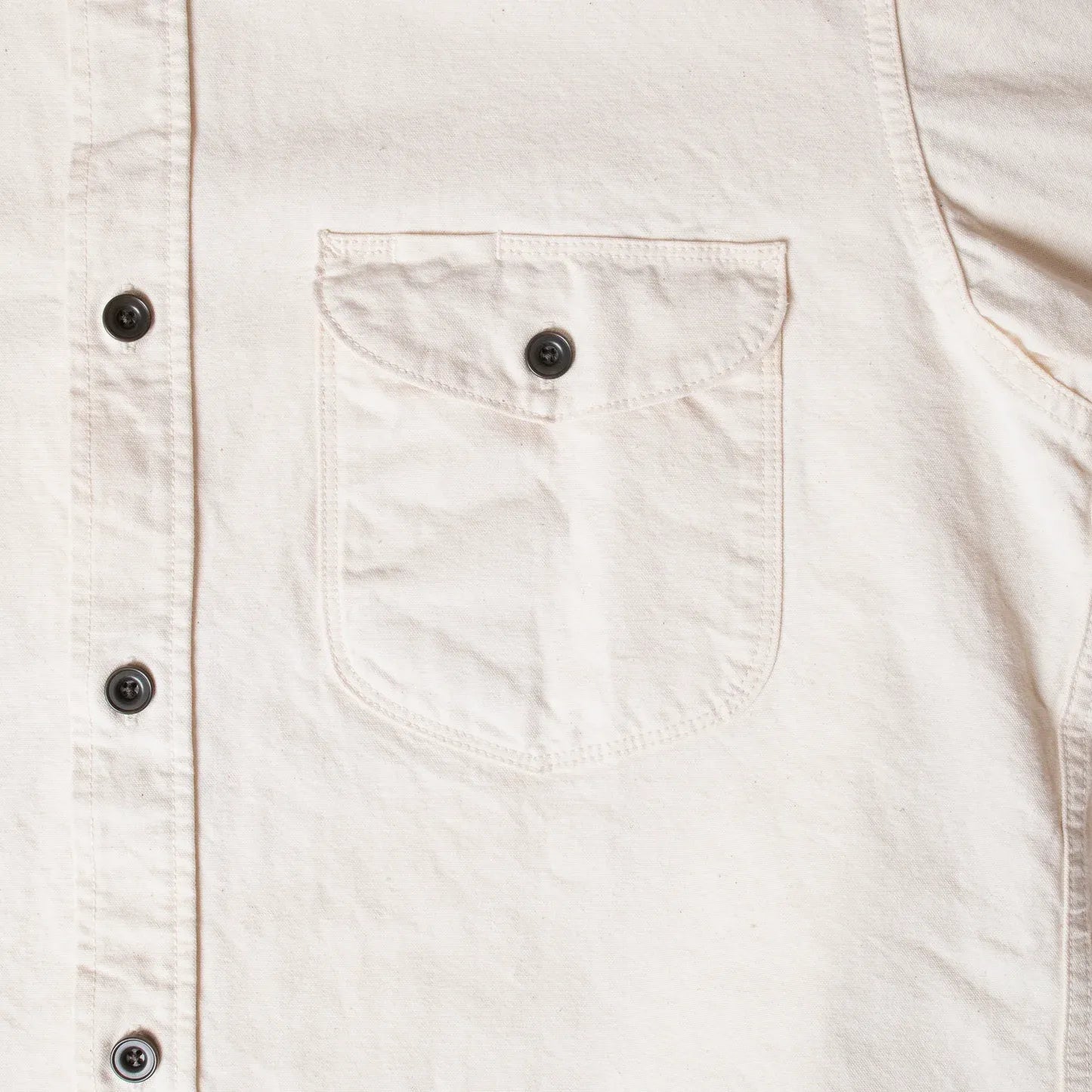 Close-up of button fastening and reinforced stitching on Seuvas 8oz Canvas Flap Work Shirt in natural.