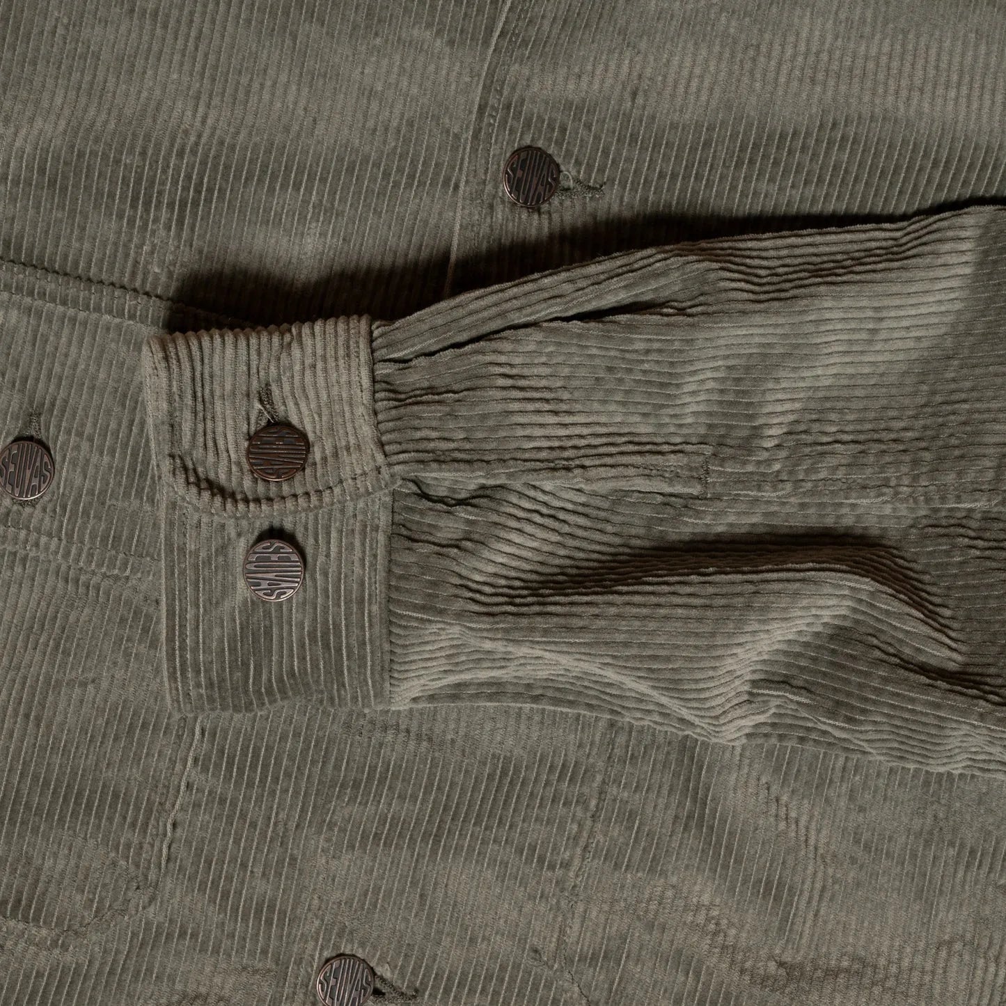 Close-up of buttoned cuff and sleeve seam detail on Seuvas Corduroy CPO Shirt in sage.