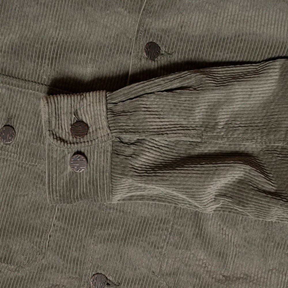 Close-up of buttoned cuff and sleeve seam detail on Seuvas Corduroy CPO Shirt in sage.