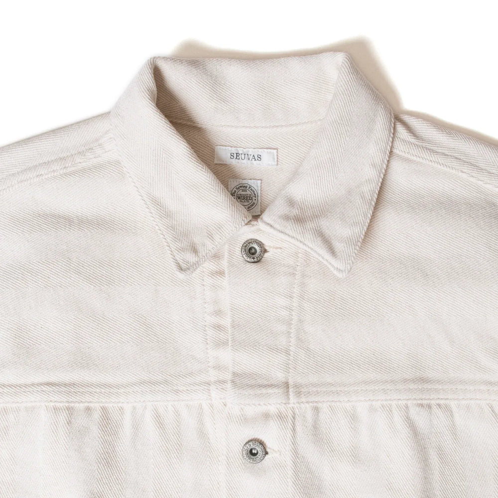 Close-up of pointed collar and stitching detail on Seuvas Herringbone Trucker Jacket in natural.