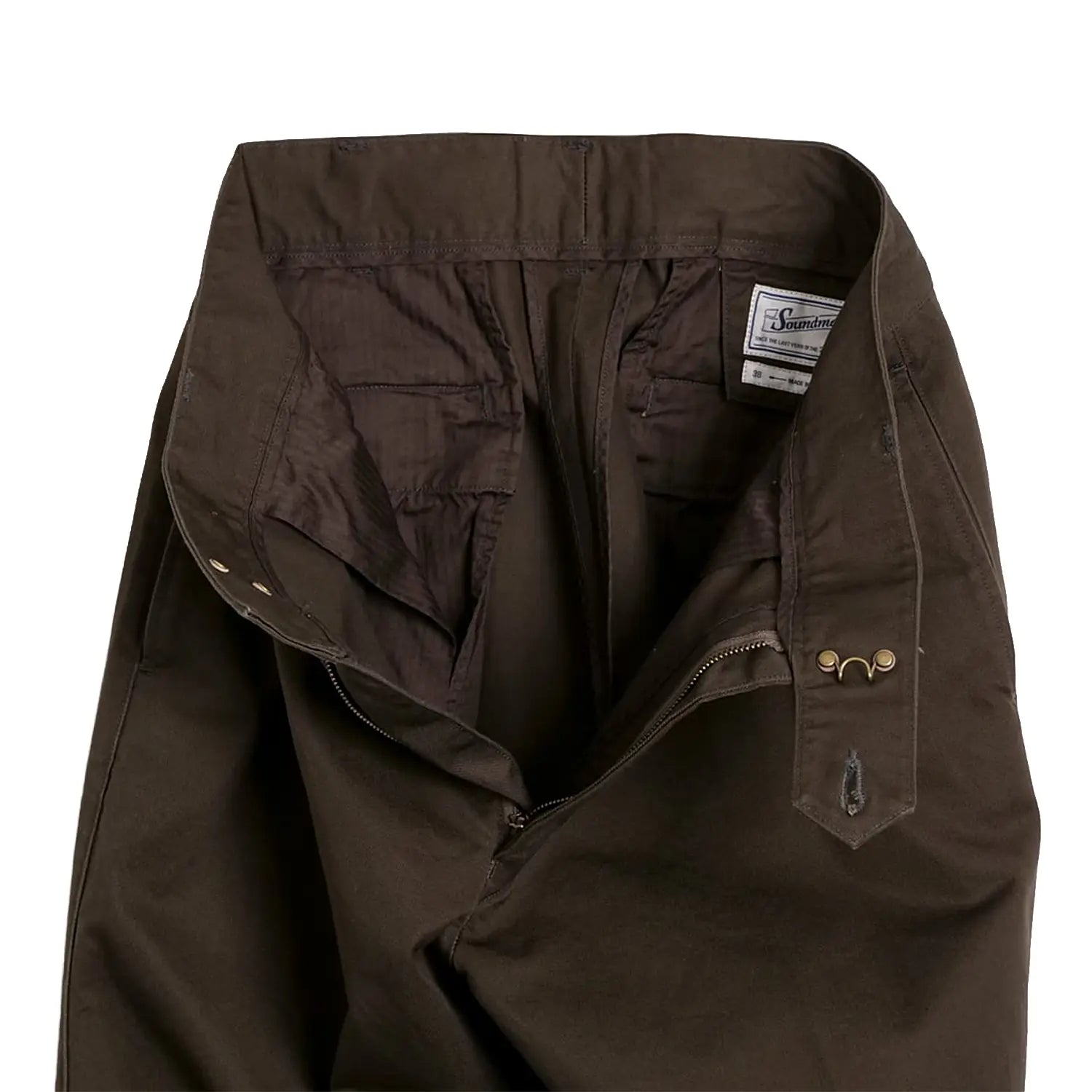 Close-up of the pleat detail showing tailored structure and stitching.