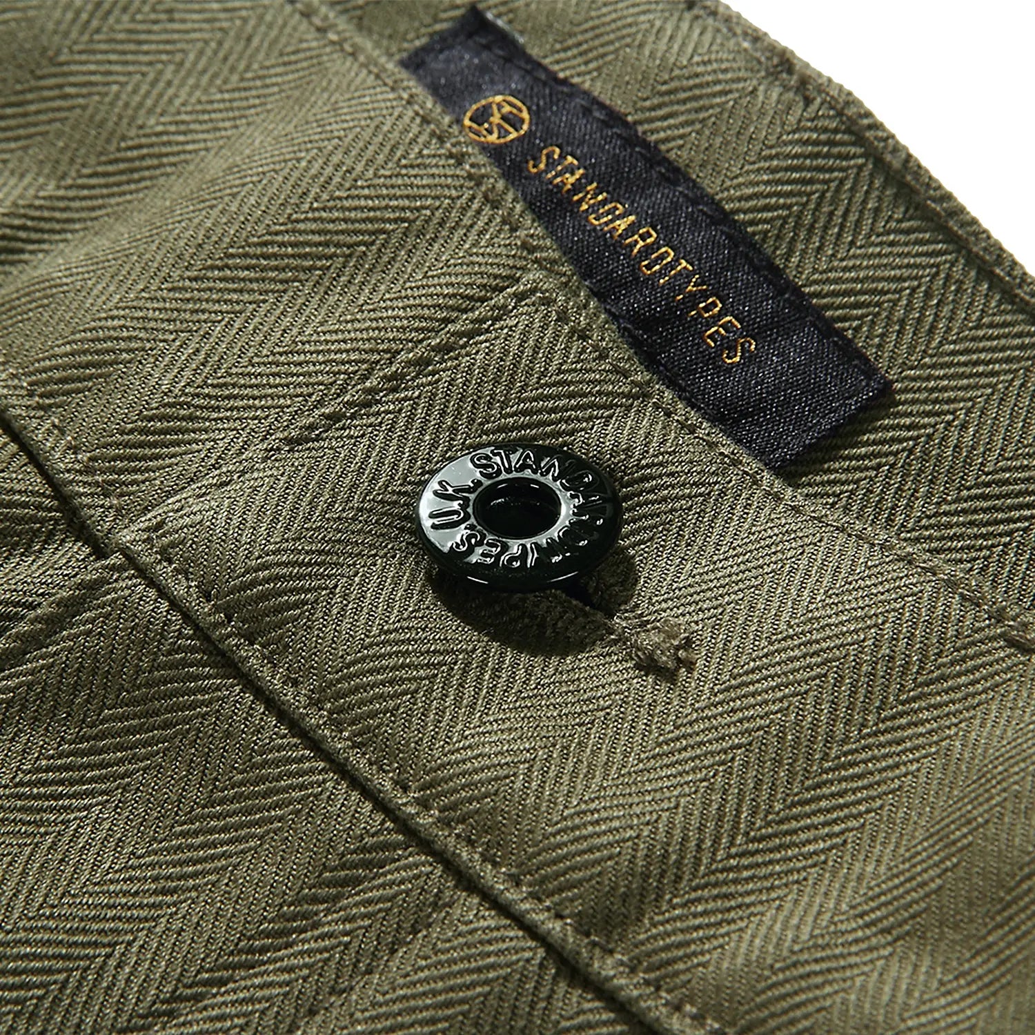 Waist detail of the StandardTypes ST040 Naval Trousers HBT Green showing button fly construction, waistband structure, and vintage naval design for Clothier & Sons.

