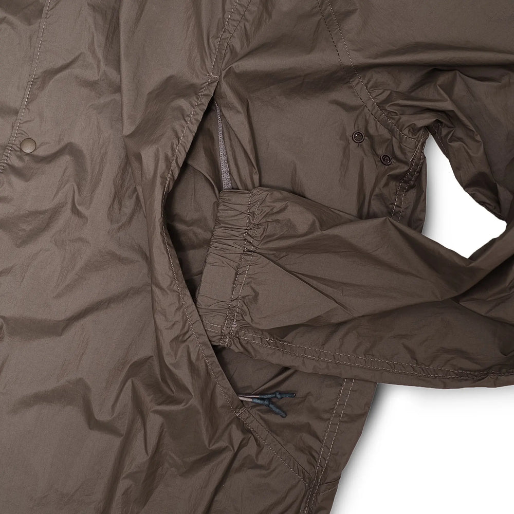 Side view of the Unaffected Blouson Track Shirt Charcoal Brown showing sleeve volume, hem shape, and balanced blouson profile for Clothier & Sons.