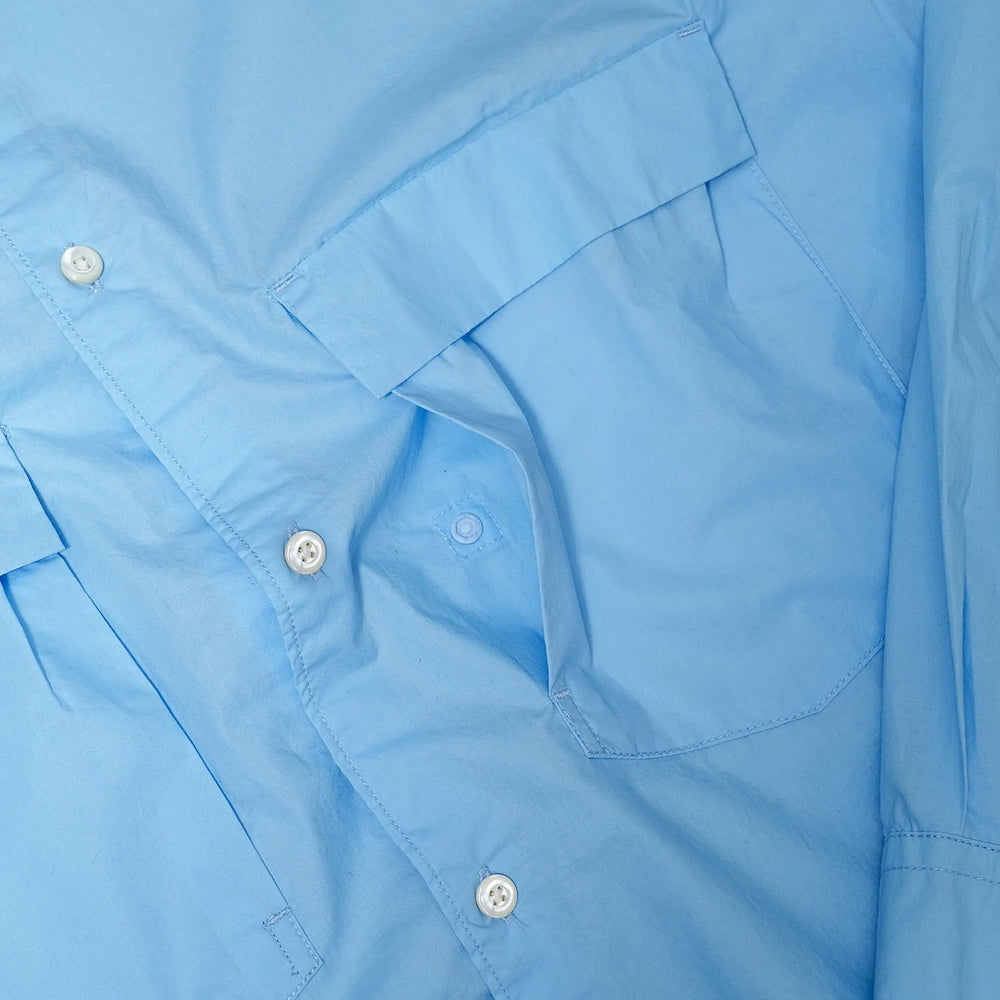 Drawstring detail of the Unaffected Drawstring Shirt Blue highlighting the adjustable hem cord, hardware detail, and functional design element for Clothier & Sons.