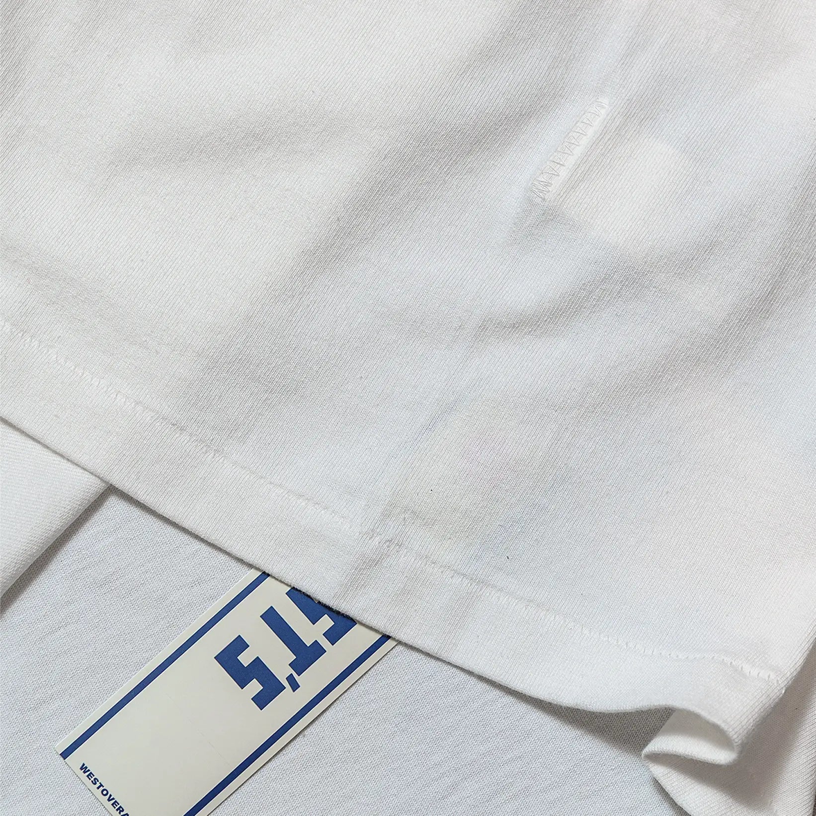 Fabric detail of the Westoverall Box Logo Print T-shirt White revealing cotton knit texture, soft hand feel, and fabric grain for Clothier & Sons.