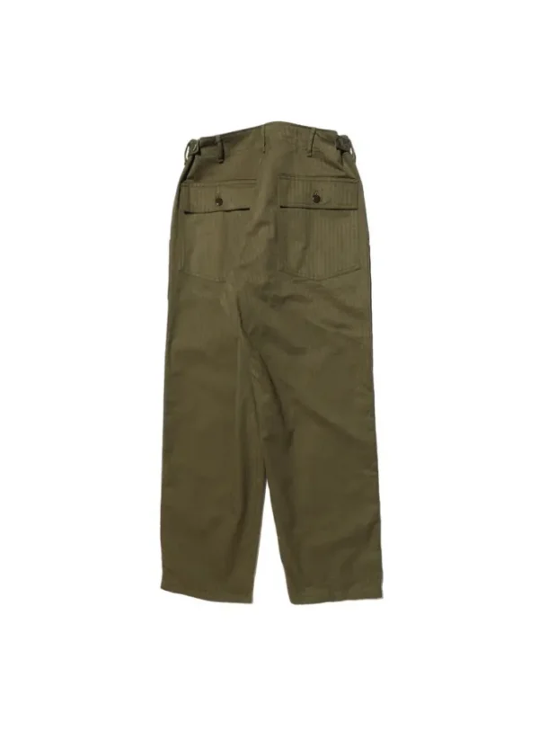 A detailed view of Baker Pants made from herringbone twill fabric, showcasing their firm texture, large side cargo pocket, and urea buttons, faithfully reproducing the U.S. military style from 1947.